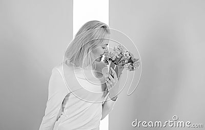 Feeling so special. Girl holding bouquet flowers enjoy favorite fragrance. Woman smiling likes to feel special attend to Stock Photo