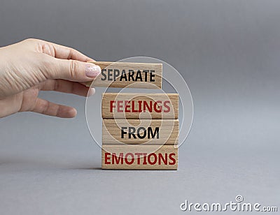Feelings and Emotions symbol. Concept word Separate Feelings from Emotions on wooden blocks. Beautiful grey background. Doctor Stock Photo