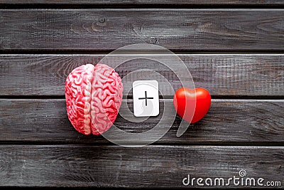 Feelings and mind concept with brain plus heart on wooden background top view Stock Photo