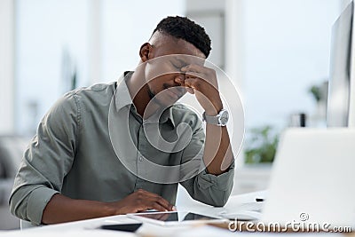 Feels like a Blue Monday. a young businessman working on a computer in an office. Stock Photo