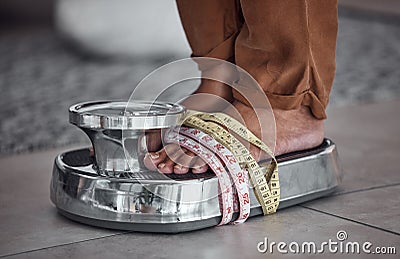 Feet, anorexia and person on scale with tape measure to check body to lose weight with stress. Balance, foot and results Stock Photo