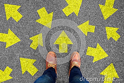 Feet and arrows on road background. Taking decisions for the future with many arrows choices, left right or move forward. Hipster Stock Photo