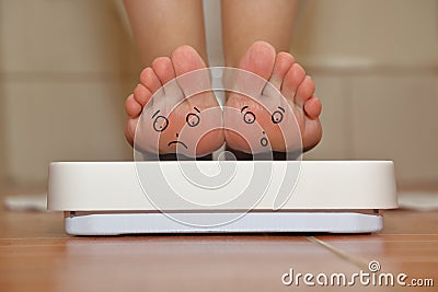 Feet on bathroom scale Stock Photo