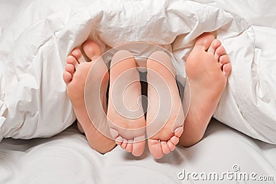 Feet in a bed Stock Photo