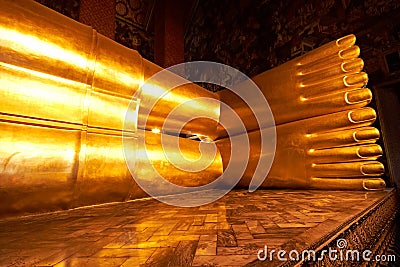 Feet of big Reclining golden Buddha statue Stock Photo