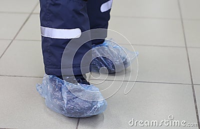 Feet in blue shoe covers. In the photo are two children feet in shoe covers Stock Photo