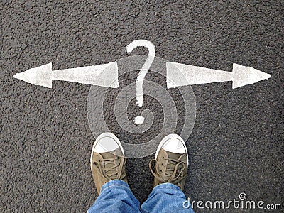 Feet standing on asphalt with arrows pointing left and right with question mark Stock Photo