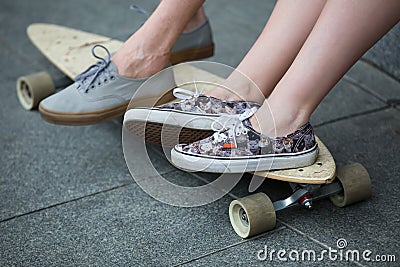 Feet couple of teenagers on the longboard closeup Stock Photo