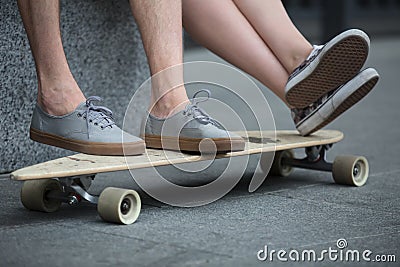 Feet couple of teenagers on the longboard closeup Stock Photo