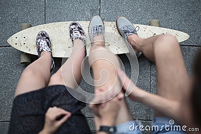 Feet couple of teenagers on the longboard closeup Stock Photo