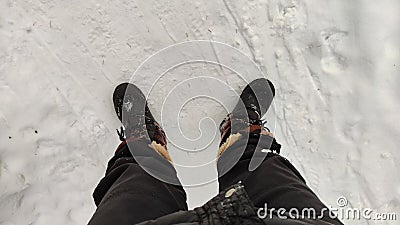 Feet of Hunter or fisherman in big warm boots on a cold winter day on snow. Top view Stock Photo