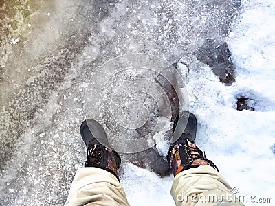 Feet of Hunter or fisherman in big warm boots on a winter day on snow. Top view. Fisherman on the ice of a river, lake Stock Photo