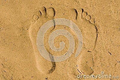 Feet imprint in sand Stock Photo