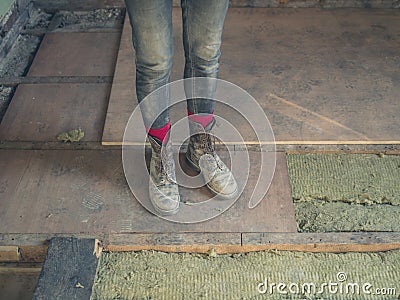 Feet and legs of worker by insulation Stock Photo