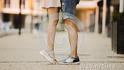 Feet of male and female close to each other, girl raising on tiptoes, dating Stock Photo