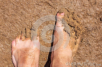 Feet of a man in dirty clay Stock Photo