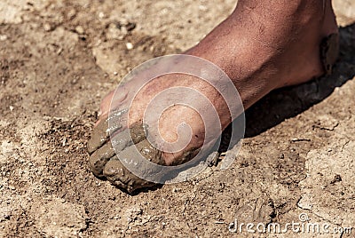Feet of a man in dirty clay Stock Photo