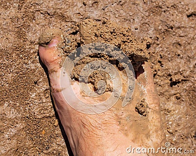 Feet of a man in dirty clay Stock Photo