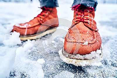 Feet of a man on a snowy sidewalk in brown boots Stock Photo