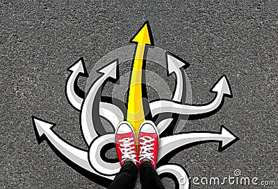 Feet and many arrows on road background. Pair of foot standing on concrete with color graffiti arrow sign choices, creative and Stock Photo