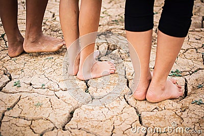 Feet people on cracked dry ground Stock Photo