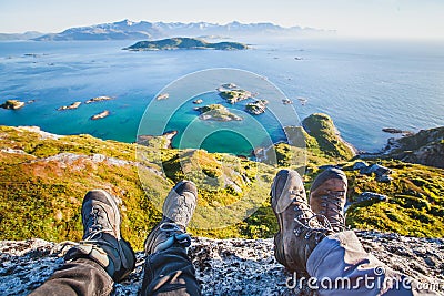 Feet of people hikers relaxing on top of the mountain, travel and hiking Stock Photo