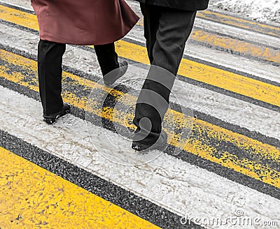 Feet of people at a pedestrian crossing in winter Stock Photo