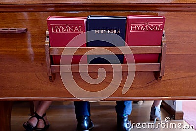 Church Pew With Bible and Hymnal Books Stock Photo