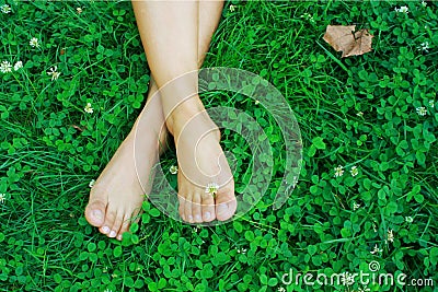 Feet resting on grass Stock Photo