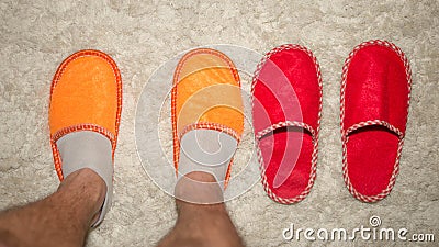 Feet in slippers on a cozy and warm rug,slippers on the rug,close-up.Top view. Stock Photo