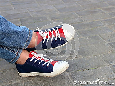 Feet sneakers in the park on Stock Photo