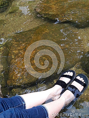 Feet soaking in the water Stock Photo