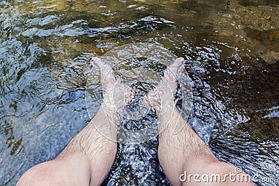 Feet soaking in the water Stock Photo