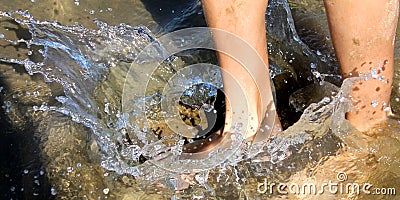 Feet splashing water. Stock Photo