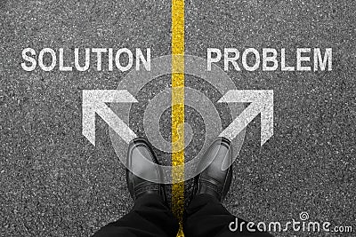 Feet and two white arrows with solution and problem. Top view of businessman on road background from above. A business man in Stock Photo