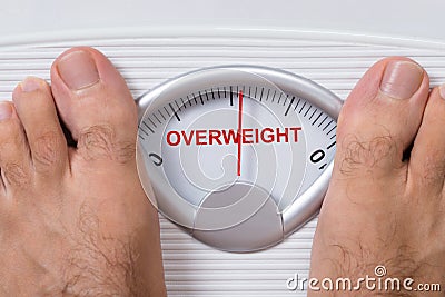 Feet on weight scale indicating overweight Stock Photo