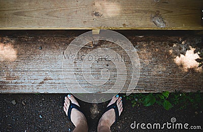 Feet with Welcome All sign Stock Photo