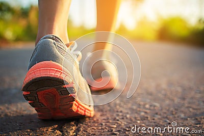Feet of woman walking and exercise on the road Stock Photo