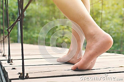 Feet women walking on bridge in nature forest Stock Photo