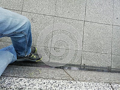 Feet pic after a long walk during the city and along the riverside of the Rhine. Waiting of the next train on the train station. Stock Photo