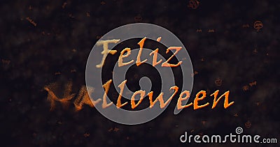 Feliz Halloween text in Spanish dissolving into dust to left Stock Photo