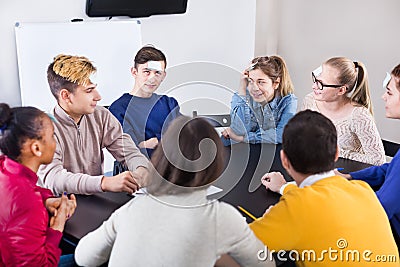 Fellow students playing guess-who game Stock Photo