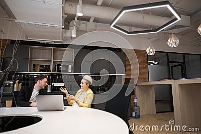Fellow workers chatting during break in office Stock Photo