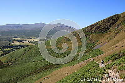 Fellwalker on hillside path, English Lake district Stock Photo