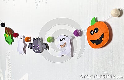 Felt garland for Halloween. Frankenstein, pumpkin, ghost, vampire and voodoo doll. Handmade fabric Stock Photo