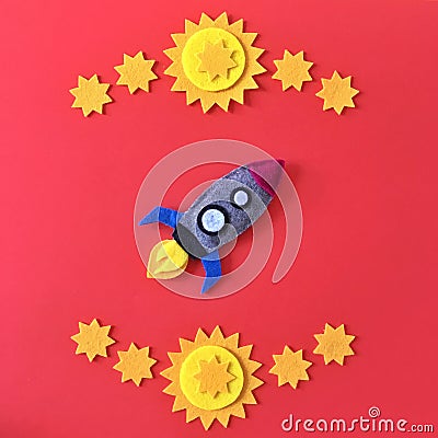 Felt Rocketship Flat Lay with Yellow Stars on Red Stock Photo