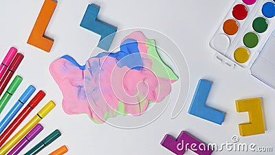 Felt-tip pens, cubes, paints and plasticine on a white background. children`s desktop. School, education and learning Stock Photo