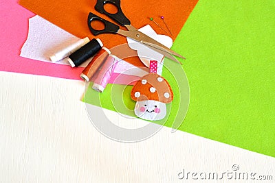 Felt toy mushroom, thread, needle, scissors, paper templates. Kids crafts Stock Photo