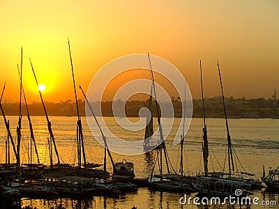 Felucca boats at the harbor at sunset, Luxor Stock Photo