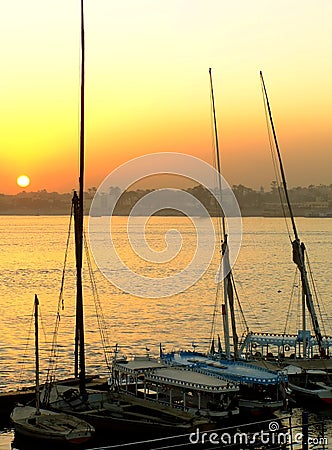 Felucca boats at the harbor at sunset, Luxor Stock Photo